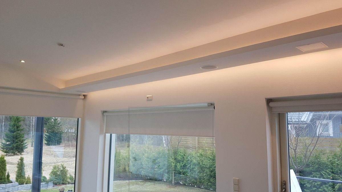 Indirect light in two directions in the living room. One led list directed down between the ceiling and the wall and the other directed up and forward from above the drop-down shelf. Ledstore.fi
